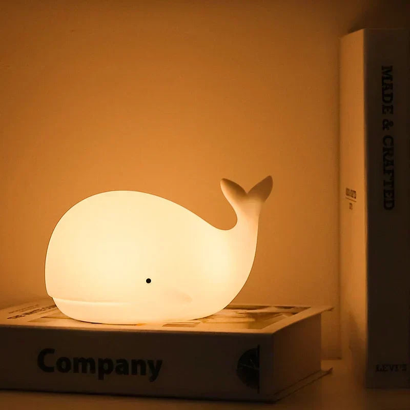 Kids' soft silicone whale night light, color-changing LED lamp for nursery & children's room decor.
