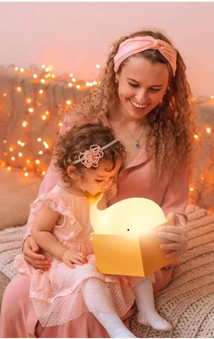 Playful whale-shaped LED night light. Soft silicone and color-changing feature perfect for kids' rooms.