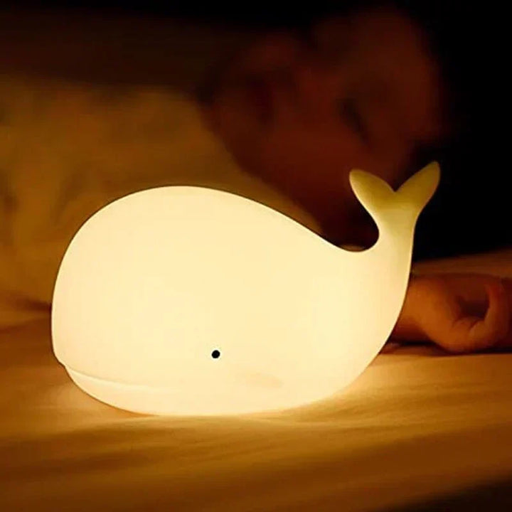 Gentle color-changing whale night light, ideal sleep aid for toddlers' bedrooms & nursery decor. Soft silicone.