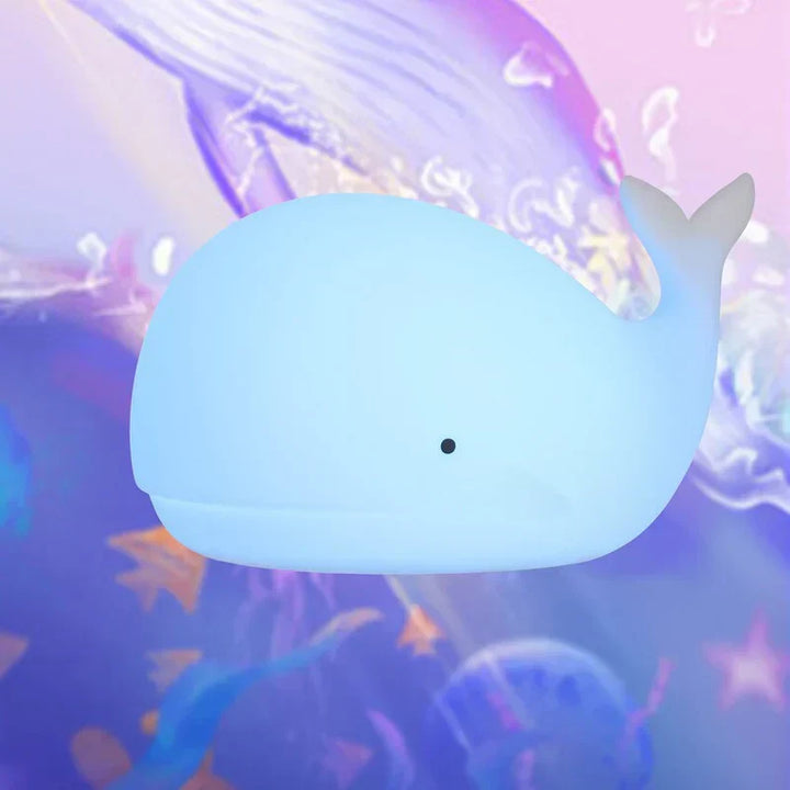 Kids' whale night light. Squishy silicone, color-changing LED provides a comforting glow for peaceful sleep.