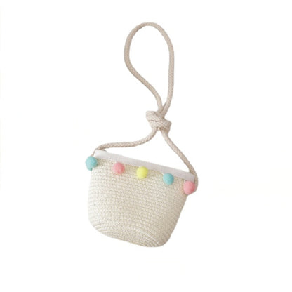 Lightweight straw sun hat for kids and a coordinating small straw bag, essential for beach or park trips.
