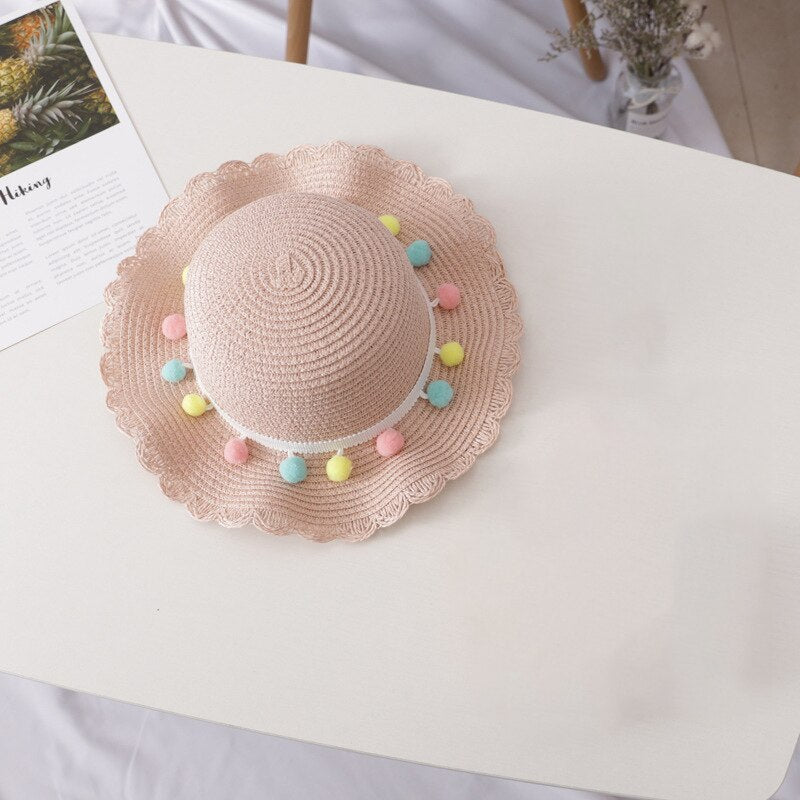 Children's fashion straw hat and bag, designed for comfortable wear and summer vacation styling.