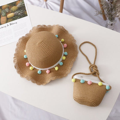 Kids' beach wear: natural straw sun hat and handbag set, providing UV protection for young adventurers.