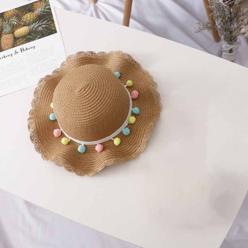 Playful straw sun hat and cross-body bag for toddlers, perfect gift for their summer wardrobe.