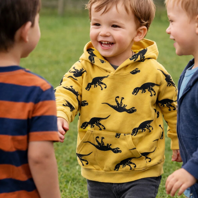 Toddler Triceratops dinosaur print hoodie, warm cotton blend, perfect winter clothing for kids.