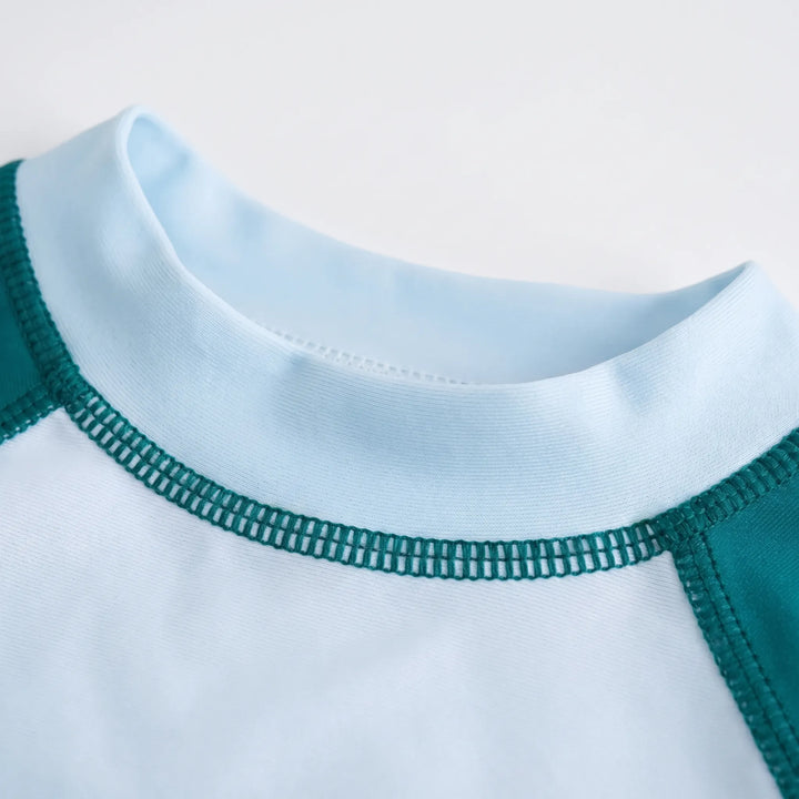 Playful kids' two-piece long-sleeve rash guard swimsuit for sun protection & pool fun. Ideal children's summer swimwear.