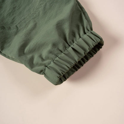 Close-up of kids unisex cargo overalls fabric, showing durable nylon texture