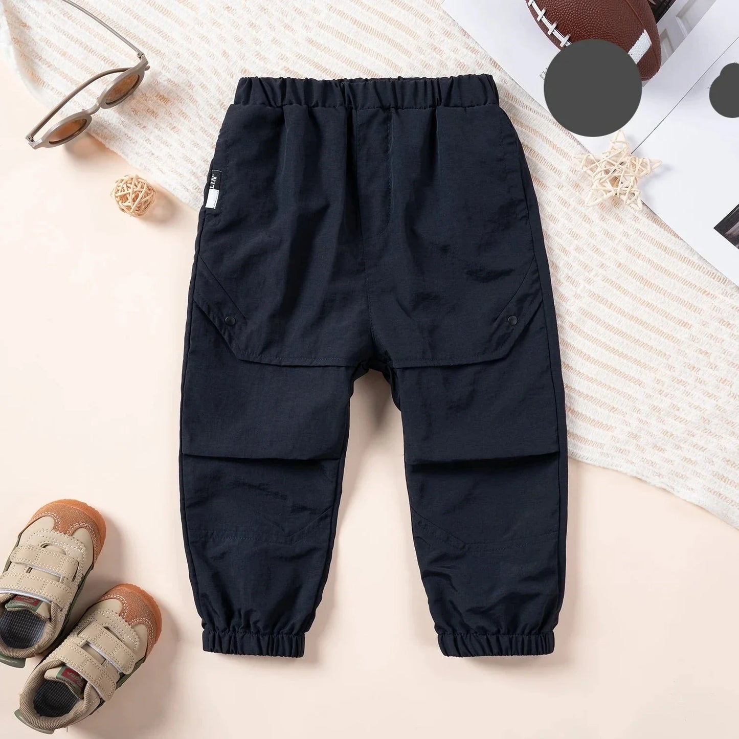 Back view of childrens unisex loose fit cargo overalls, spring playwear