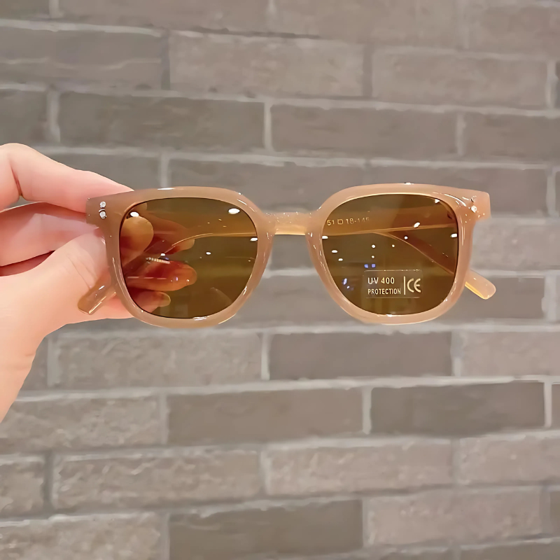Boy wearing vintage square UV400 sunglasses, enjoying outdoor play, showing durable children eyewear