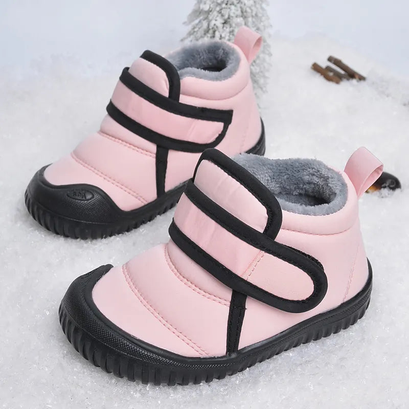 Childrens' pink winter boots with hook and loop fasteners, water-repellent design.