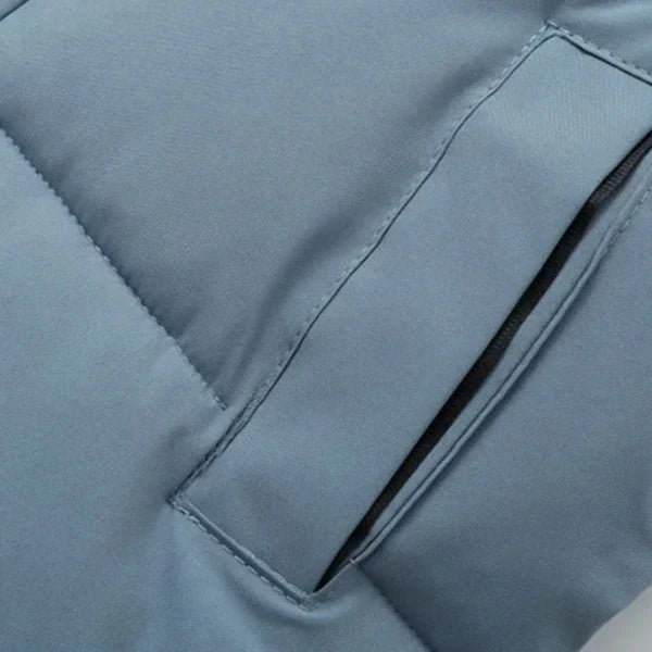 Back of a navy blue children's warm cotton puffer jacket, featuring a protective hood