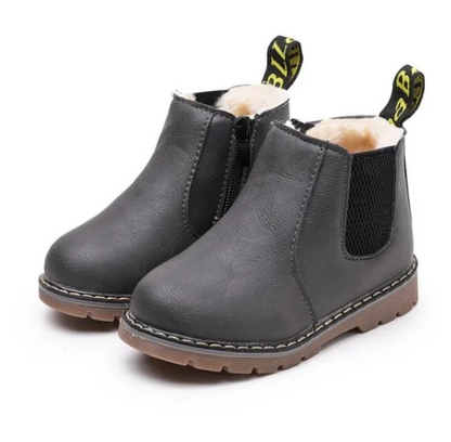 Kids' black waterproof Chelsea boots, side zipper, non-slip, essential footwear for winter play.