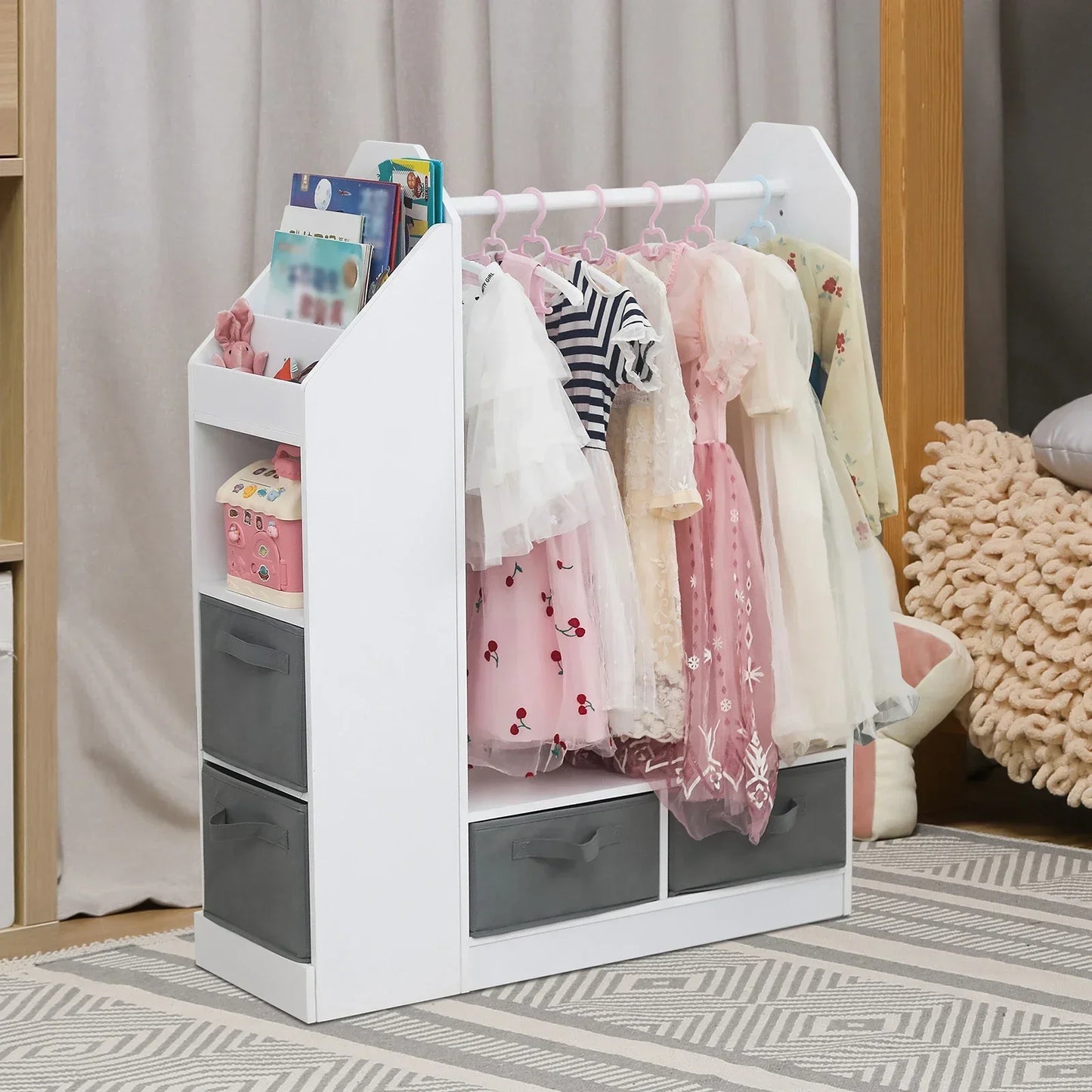 Kids' white wooden dress-up closet with mirror, hanging rail & storage shelves for costumes & accessories.
