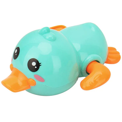 Happy toddler enjoying bath time with a wind-up duck floating bath toy