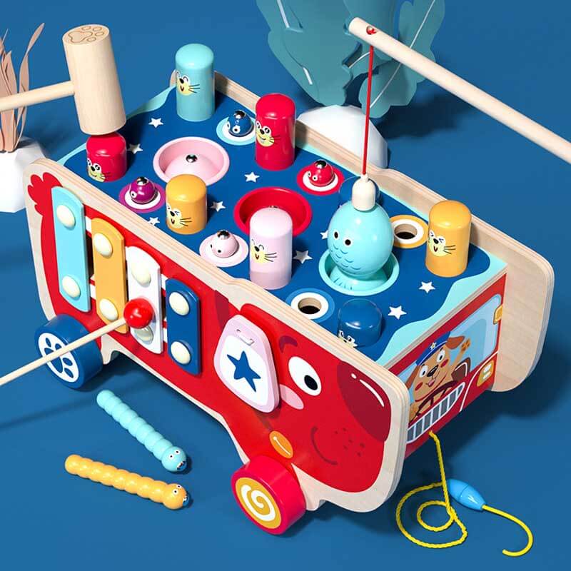 Toddler playing with colorful mallets on the wooden 5-in-1 Whack-A-Mole activity cart, an early learning toy.