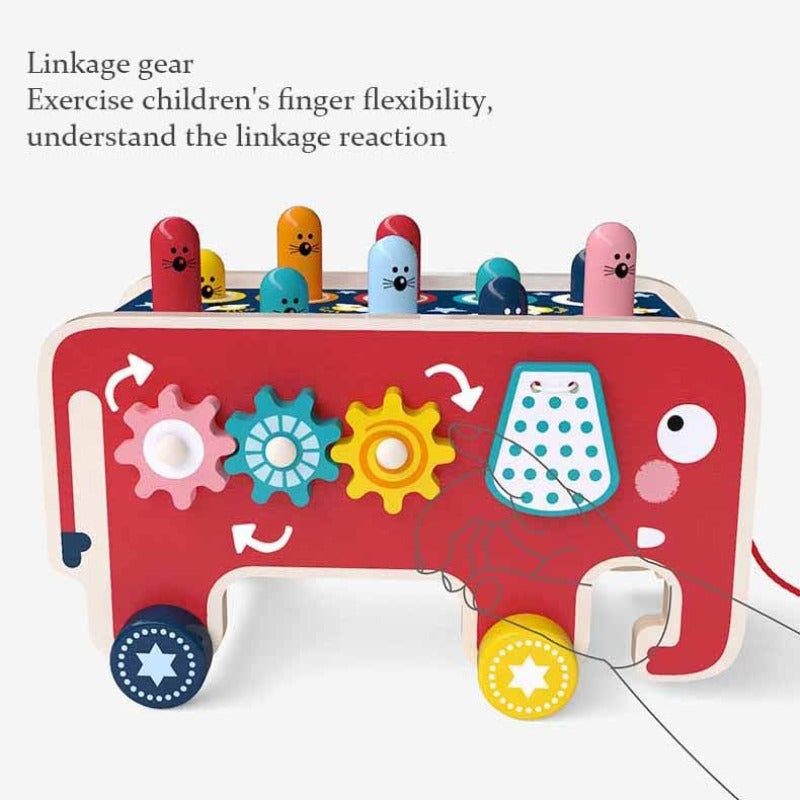 Close-up of the wooden Whack-A-Mole game on a kids activity cart, an educational toy for toddlers.