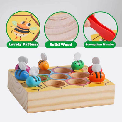 Toddler picking up a wooden bee with yellow tweezers, matching game toy
