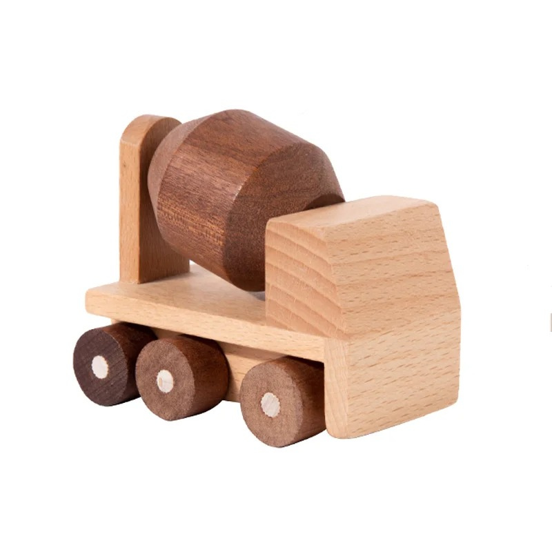 Child's hand reaching for a wooden excavator toy block, fostering motor skills & creativity in toddler play.