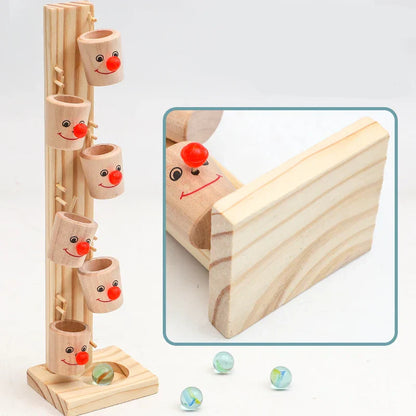 Close-up of a kids wooden clown ball track with a rolling red ball, showcasing craftsmanship