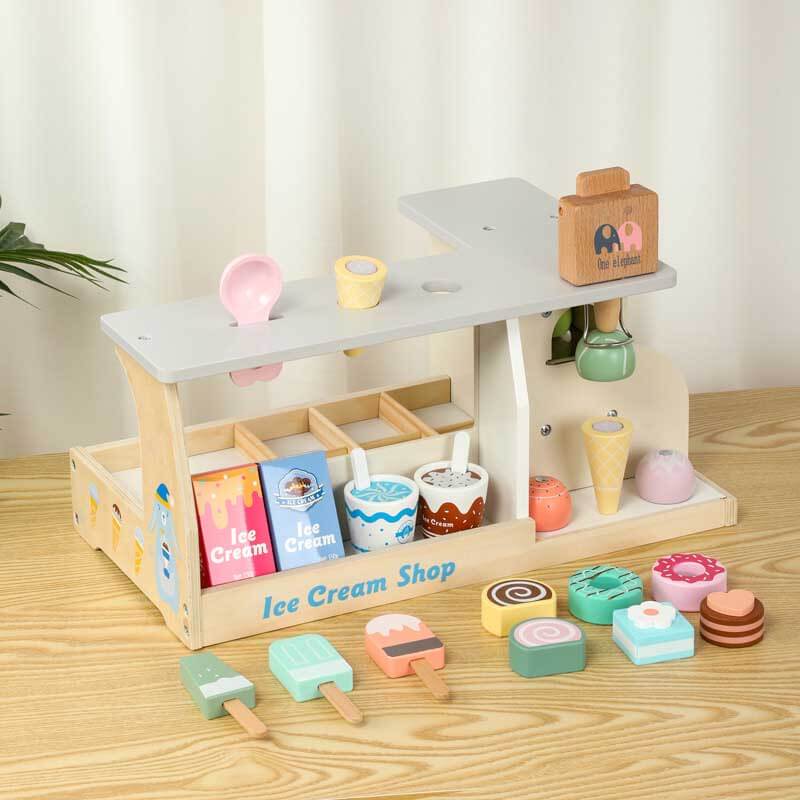 Kids wooden ice cream shop counter set with colorful scoops, cones & toppings for pretend play.