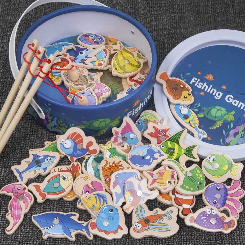 Toddler playing with a wooden magnetic fishing game, catching a red fish with a pole, a fun learning toy