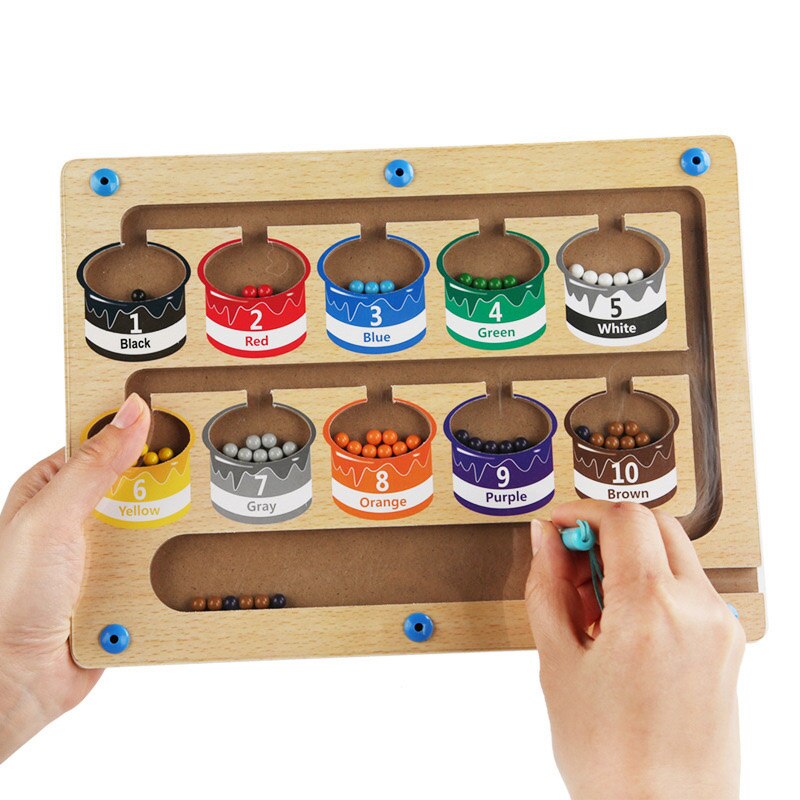 Toddler playing with a colorful magnetic number sorting maze puzzle, an educational preschool learning toy