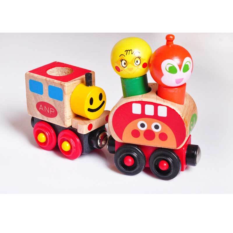 Close up of wooden magnetic train with cheerful cartoon characters, ideal for toddler play