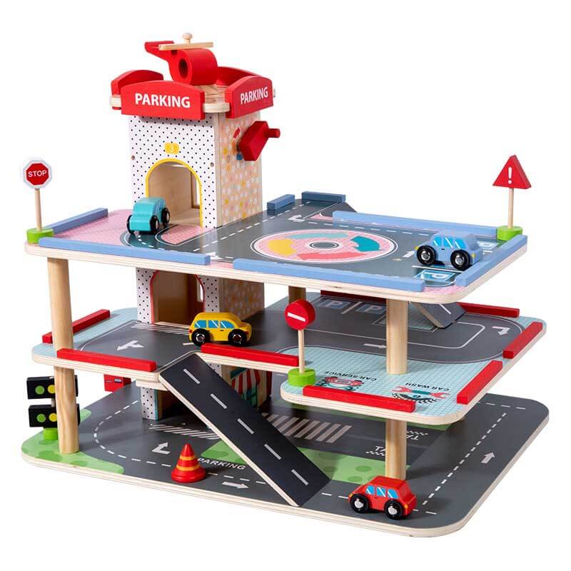 Little hands playing with toy cars on a wooden multi-level parking garage activity playset