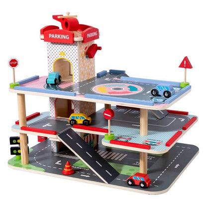 Little hands playing with toy cars on a wooden multi-level parking garage activity playset