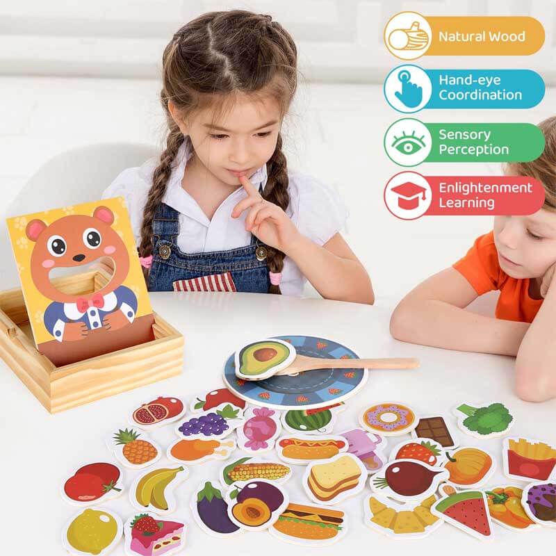 Toddler engaged with wooden feeding game, educational pretend play toy for children's development