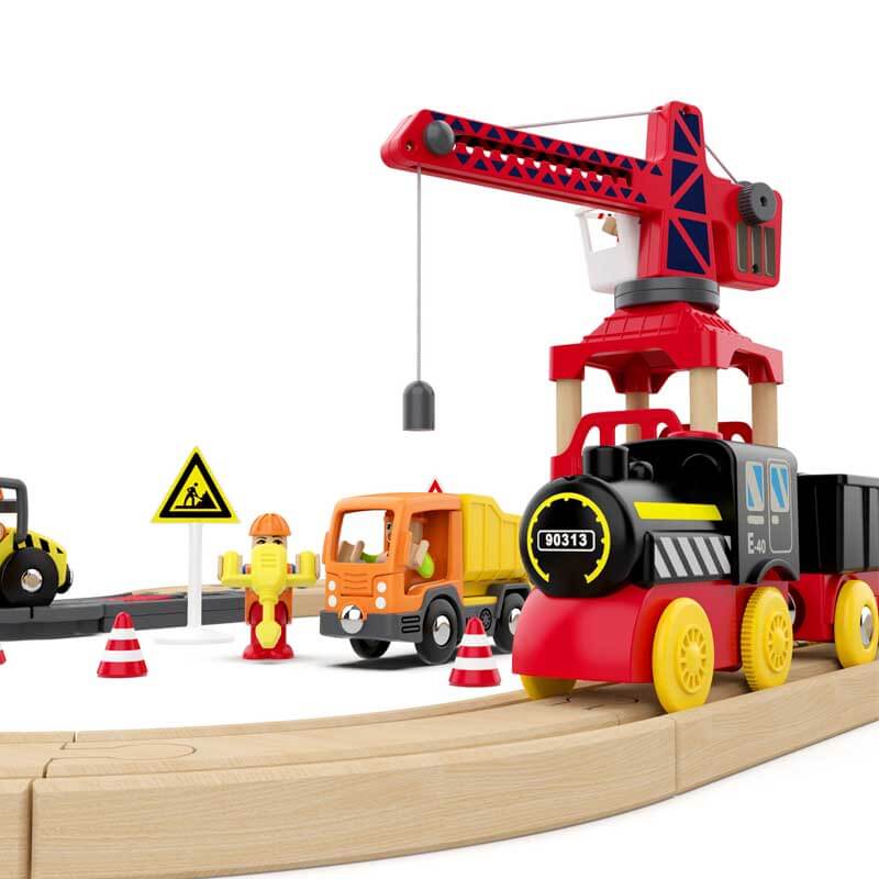 Battery-operated red train engine from a kids wooden set, pulling two colorful wooden cars