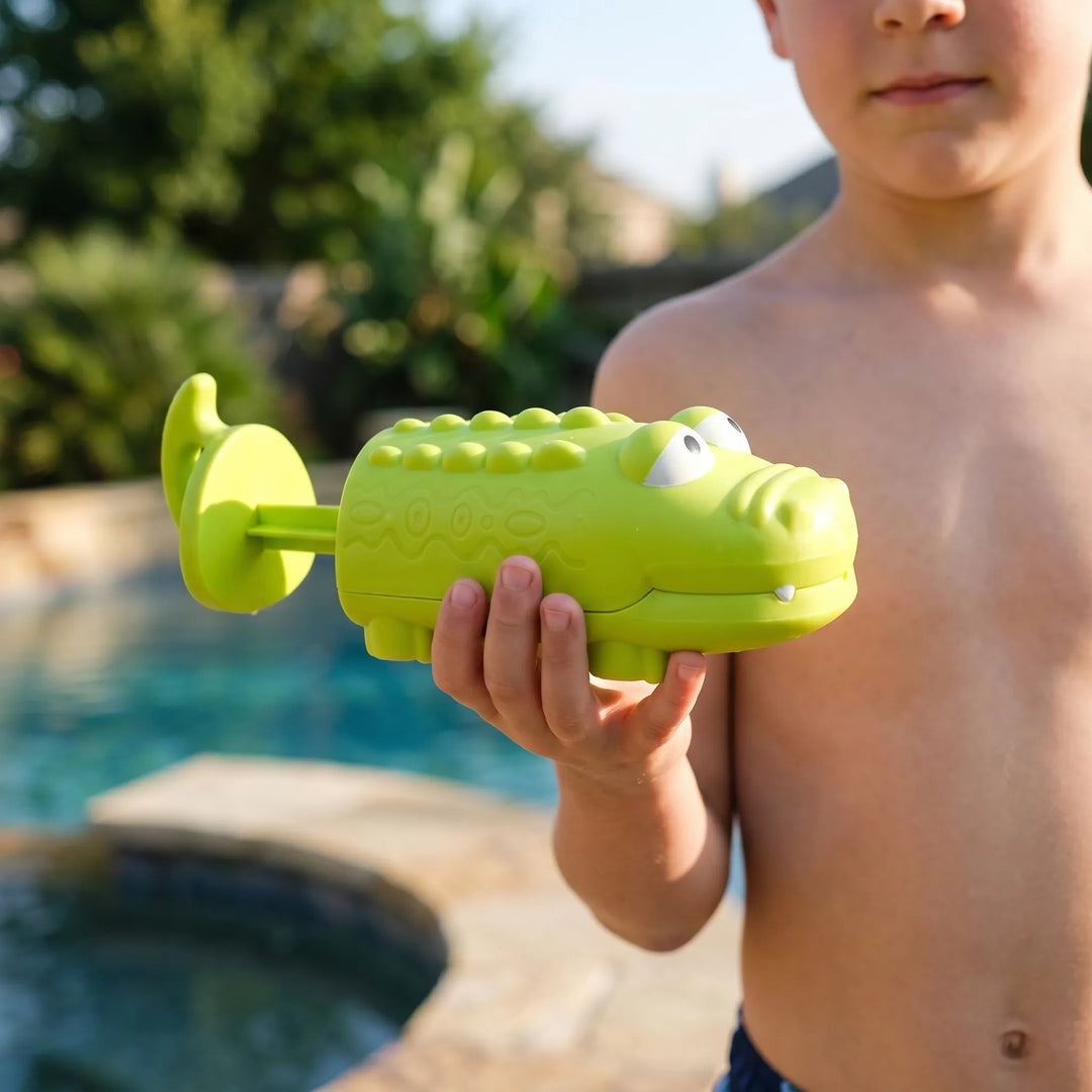 Green frog water squirter for kids' pool parties & bath time; fun outdoor play toy.
