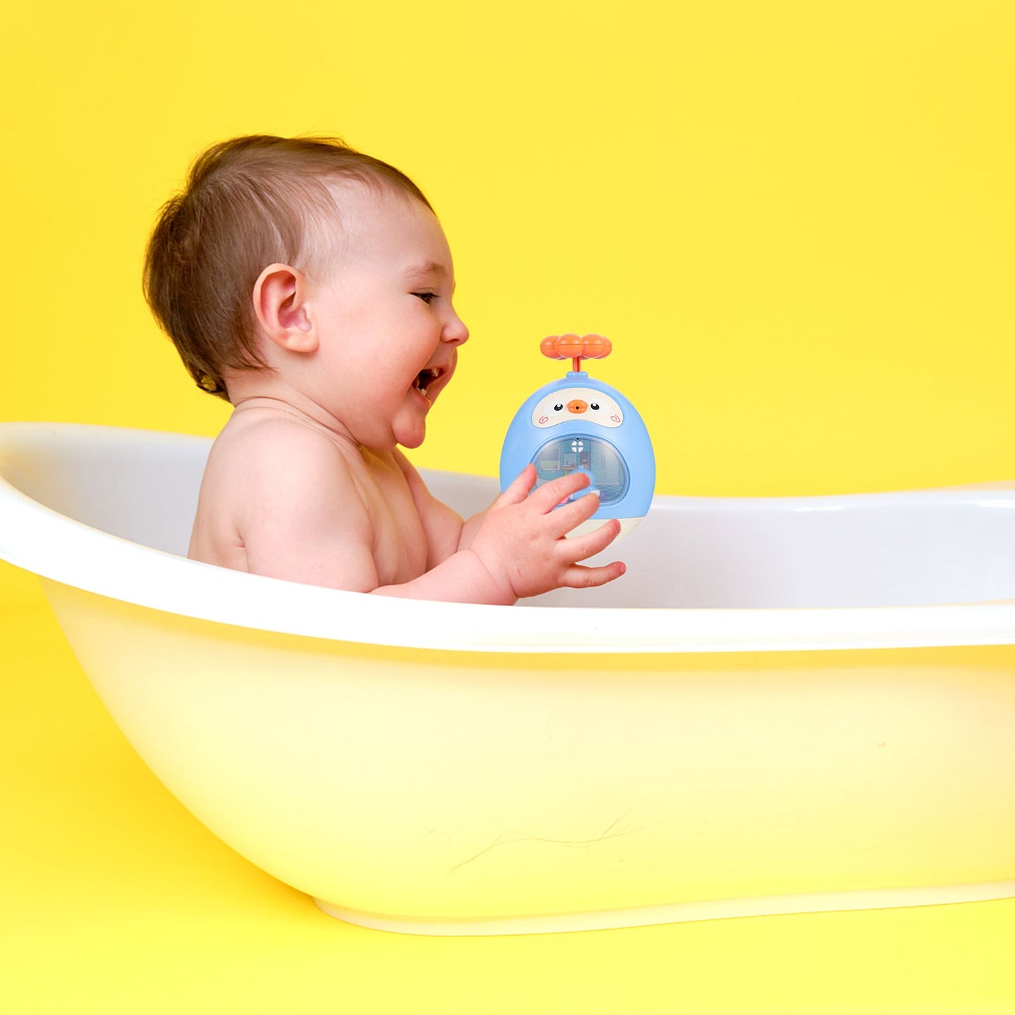 Toddler toy: yellow duck sprinkler for kids' bath time, promoting safe and enjoyable water play.