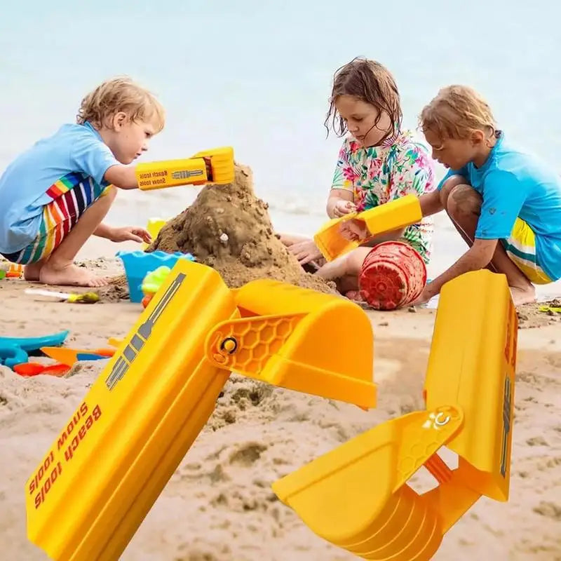 Close-up of a child's hand operating the controls of a creative sand digger toy on a sunny beach