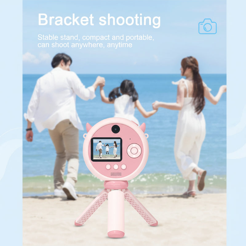 Child recording Full HD video with a durable pink KidSnap digital camera outdoors