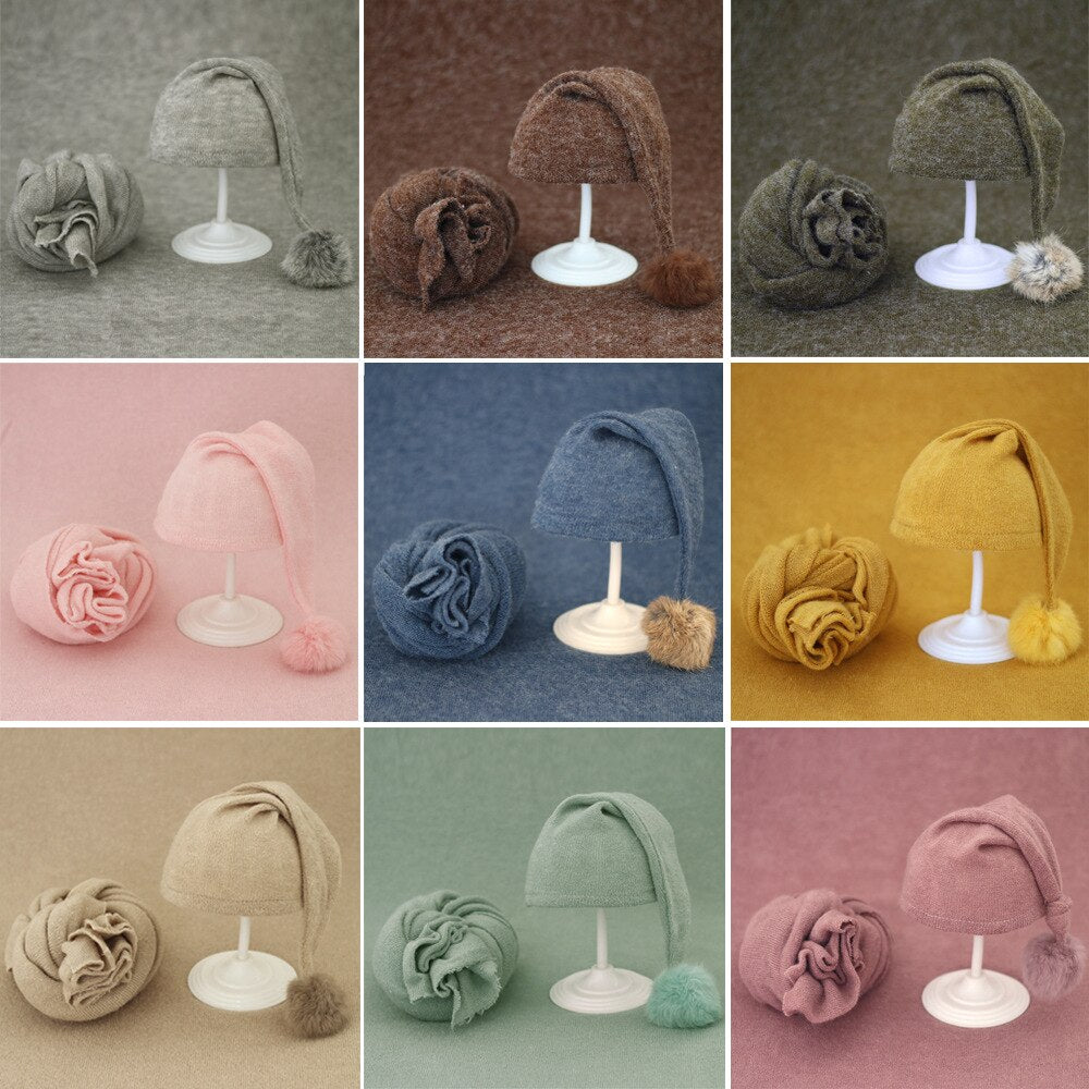 Essential baby accessories: knitted wrap and fur ball hat for newborn pictures.