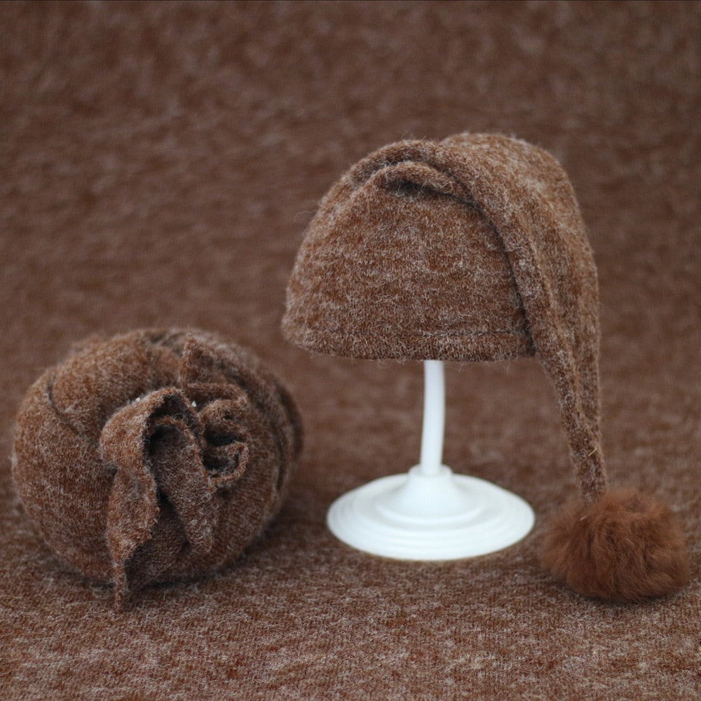 Cozy knitted baby swaddle and fur pom hat, ideal infant photoshoot accessory.
