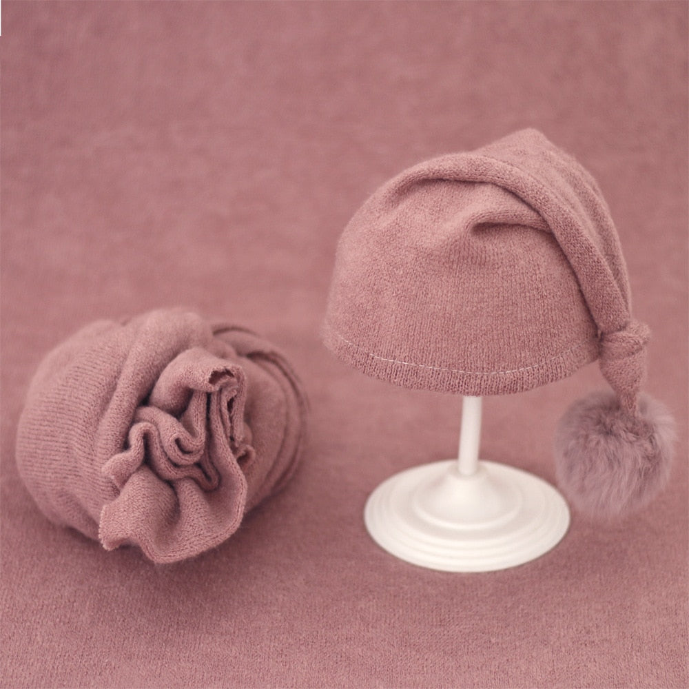 Baby accessories: knitted swaddle wrap & hat with fur ball for newborn comfort.