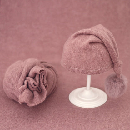 Baby accessories: knitted swaddle wrap & hat with fur ball for newborn comfort.