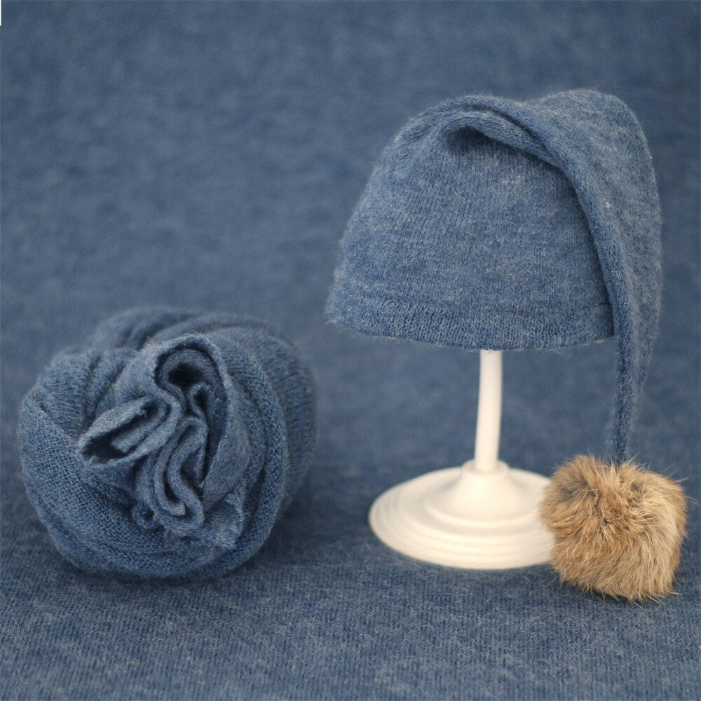 Adorable baby knitted wrap & fur ball hat set, essential for baby photoshoots.