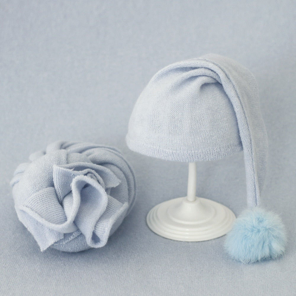 Infant swaddle wrap & fur ball hat set, soft & comfortable baby photoshoot attire.