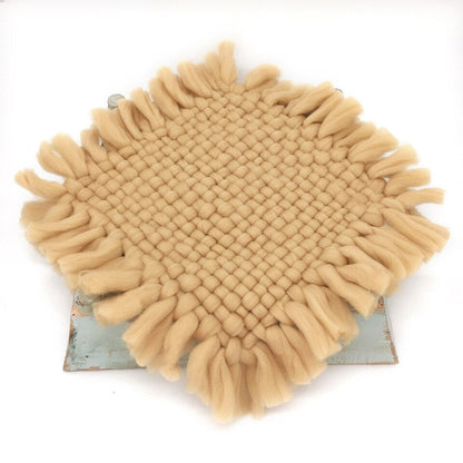 Close-up of textured knitted baby blanket, ideal newborn photography prop for infants
