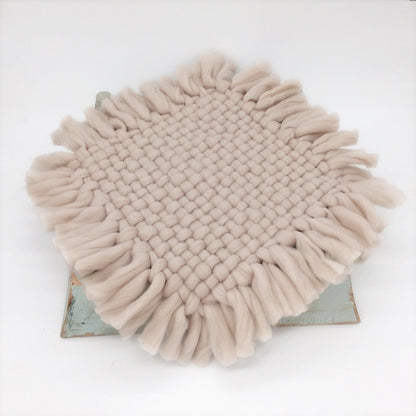 Small infant on a knitted baby blanket, showcasing product as a comfortable newborn photography prop