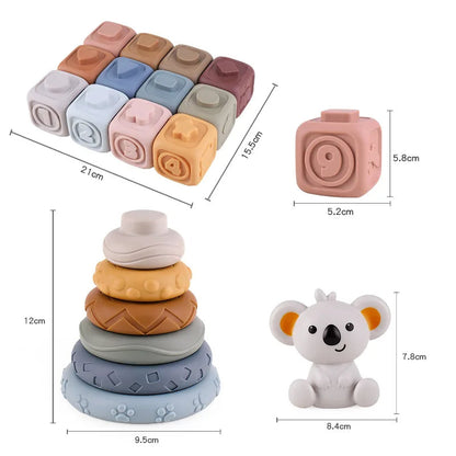 Infant exploring soft Koala Cubes silicone teether, a multi-sensory stacking and chewing toy
