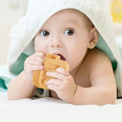 Baby reaching for Koala Cubes teether, a safe and fun silicone toy for early learning