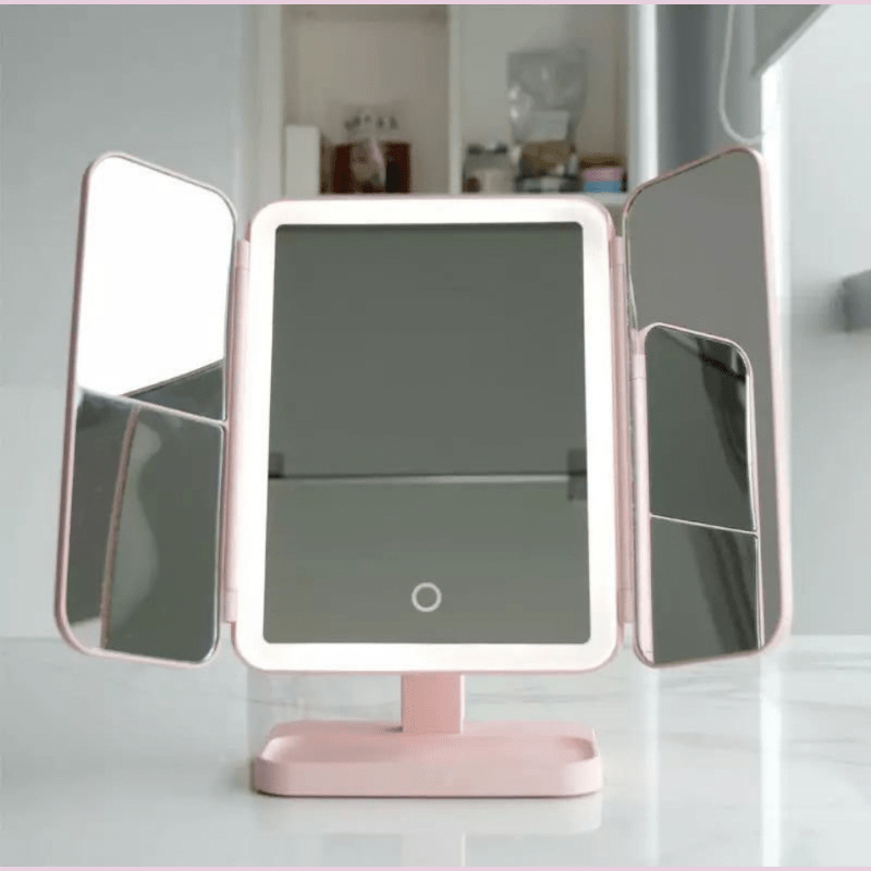 Modern cosmetic LED tabletop mirror featuring tri-fold design & 3 light settings for perfect beauty routines.