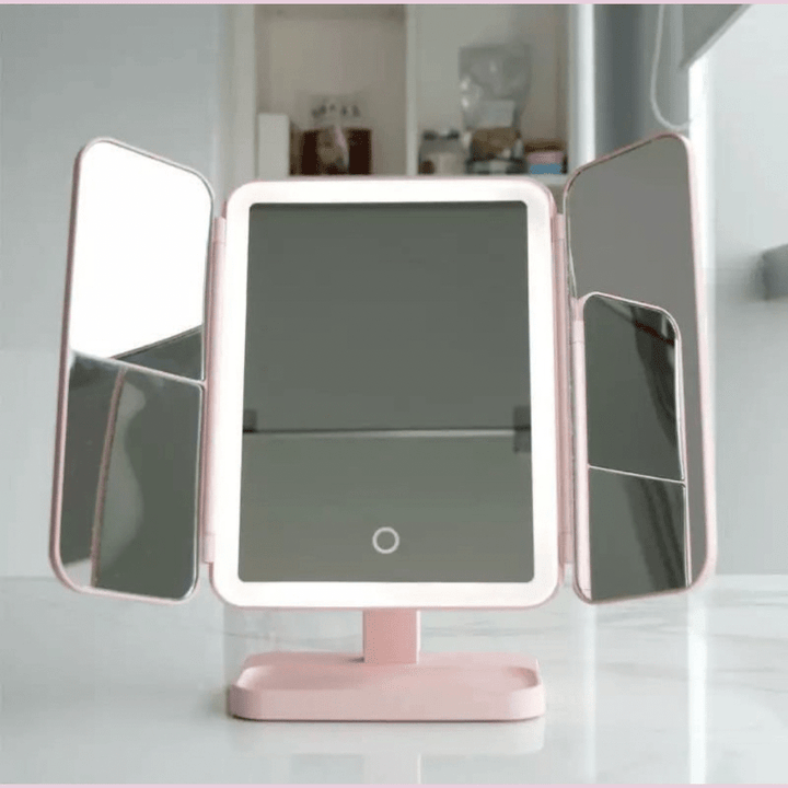 Modern cosmetic LED tabletop mirror featuring tri-fold design & 3 light settings for perfect beauty routines.