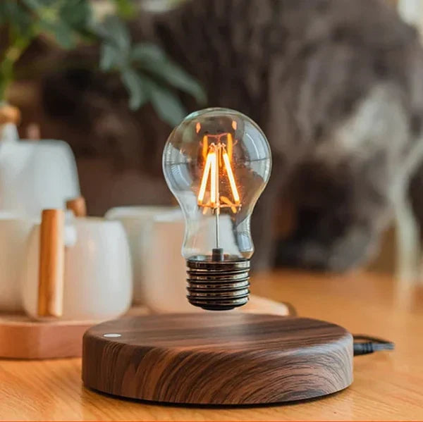 Levitating light bulb with elegant walnut wood base. Unique electromagnetic floating lamp for modern home decor.