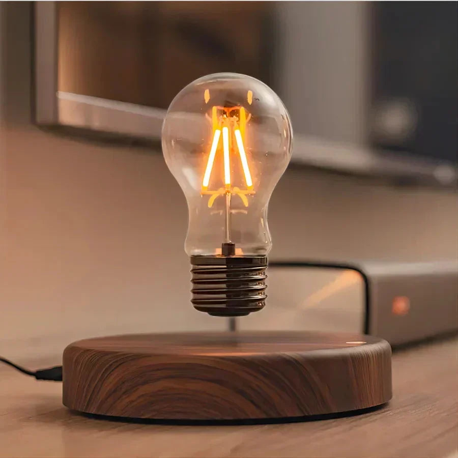 Modern levitating light bulb with a sleek walnut base. Perfect floating desk lamp for a unique ambiance light.