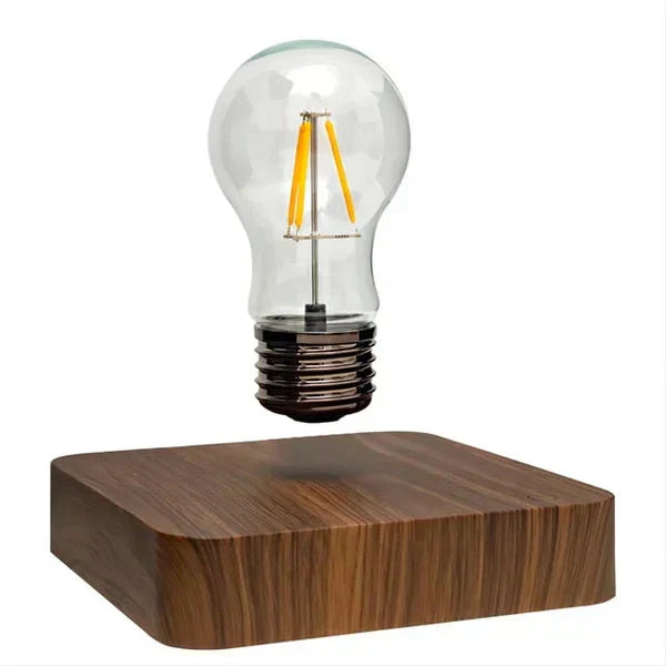 Electromagnetic levitating light bulb, a futuristic floating lamp. Walnut wood base home accent for modern decor.